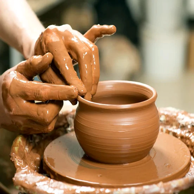 Row of high-grade pottery throwing wheels in our well-lit main workshop area